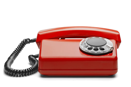 Landline red phone on isolated background with a shadow
