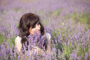 a pregnant woman in a field of flowers of lavender purple