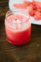 Delicious watermelon smoothie on the wooden board. Smoothie - vegetarian coctail from fresh fruit - watermelon