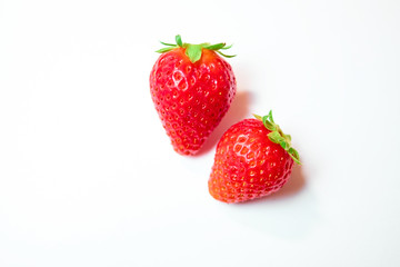 Two berries of strawberries on white background
