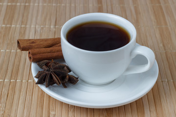 Cup of coffee beans with cinnamon and anise
