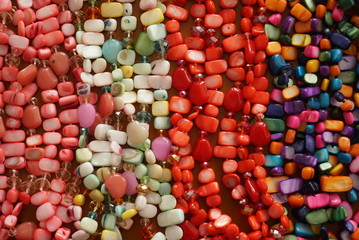 Colored Precious Stones Jewelery on a Wooden Background