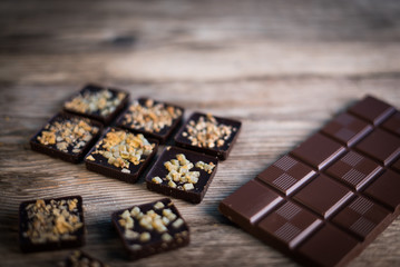 Chocolate bar pieces with cocoa powder. Background with chocolate. Slices of chocolate, Copyspace