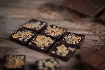 Chocolate bar pieces with cocoa powder. Background with chocolate. Slices of chocolate, Copyspace