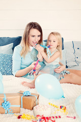 Obraz na płótnie Canvas Mother and Daughter Having Fun with Birthday Gift Box and Balloons. Mother and Child Girl having Fun. Happy Loving Family