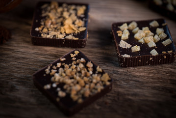 Chocolate bar pieces with cocoa powder.  Background with chocolate. Slices of chocolate,  Copyspace