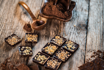 Fototapeta na wymiar Chocolate bar pieces with cocoa powder. Background with chocolate. Slices of chocolate, Copyspace