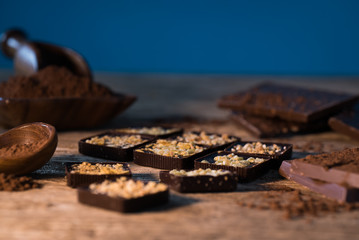 Chocolate bar pieces with cocoa powder.  Background with chocolate. Slices of chocolate,  Copyspace