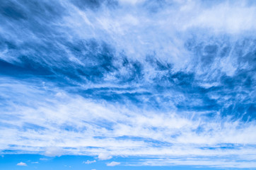 Fluffy small cirrostratus , cirrocumulus and cirrus cloud formations blue sky.