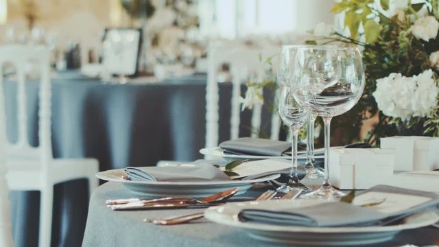 Decorated wedding table. Wedding reception venue with flowers.