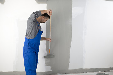 Manual Worker Painting House Interior 
