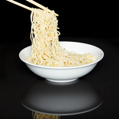 Noodles in the bowl with chopsticks