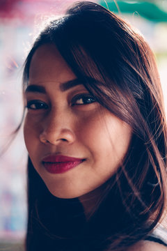 Portrait of a beautiful Asian girl with dark red lipstick