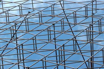 Metal scaffolding against blue sky background