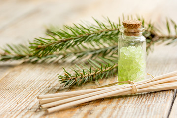 Spruce spa with organic salt in bottles on wooden table background