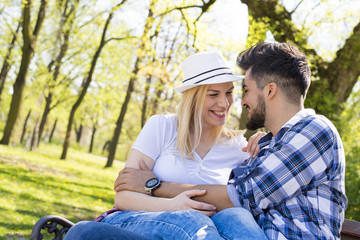 Flirting couple having fun in park on beautiful sunny day