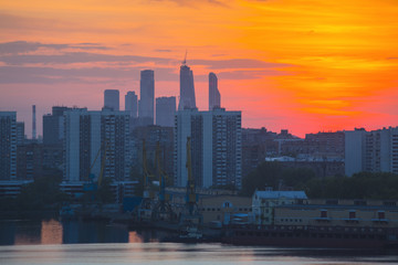 Fototapeta na wymiar Sunrise at the city. Silhouette of buildings.