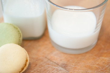 milk and cookies on a wooden table with vintage milk bottle