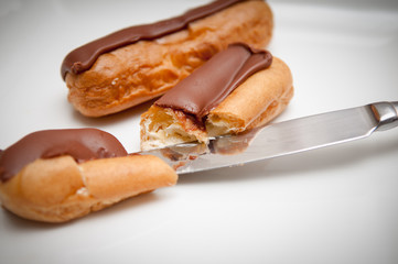 Fresh cream cakes being cut into slices