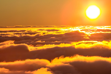 Sunset over the clouds