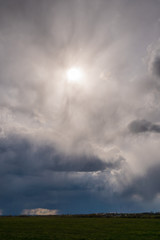 Dramatic cloudy sky with the sun, vertical composition