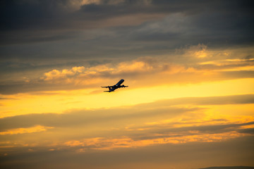 Plakat Silhouette of airplane at sunset...