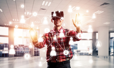 Guy wearing checked shirt and virtual mask reaching hand to touc