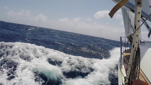 POV yacht cruising on the sea, ocean in summer day. Tourism, extreme sport, outdoor activities. Walking on a yacht at high speed. Sea seen through yacht bridge. Beautiful blue sea with foam waves