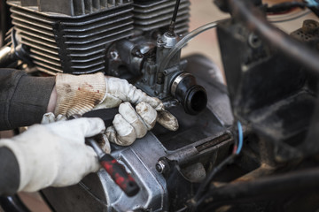 Obraz premium Process of caring and maintain an old motorcycle, retro