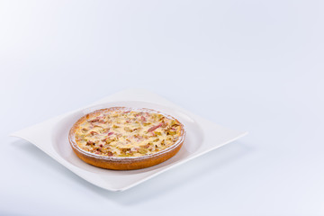 Rhubarb tart on a beautiful white dish isolated on white background