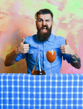 Brutal caucasian hipster with alcohol cocktail and flask