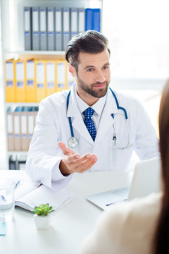 Vertical photo of a professional doctor having a consultation with his patient