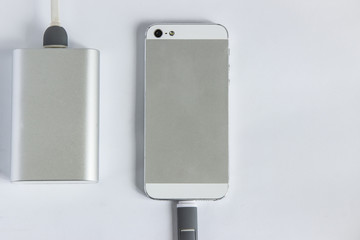 Smartphone with grey  portable external battery  on a white background