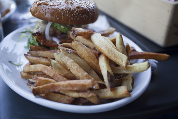 Chicken sandwich with French fries.