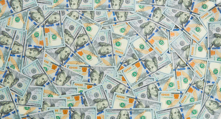 Background from scattered dollar banknotes as abstract seamless.