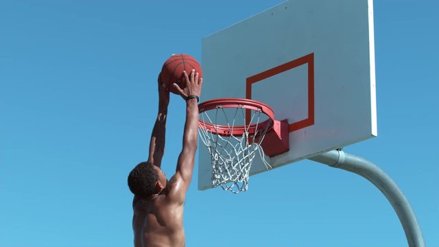 Super slow motion shot of basketball slam dunk
