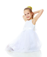 Beautiful little girl in a white dress