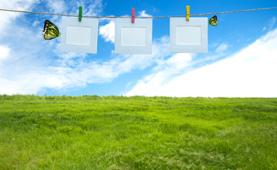 Vacation photos hanging on a rope, blue sky background