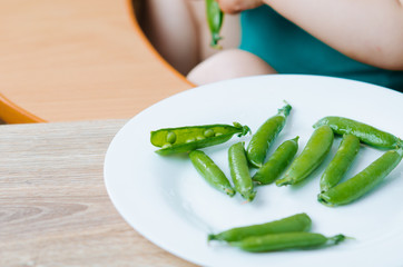 Little eats peas in the kitchen