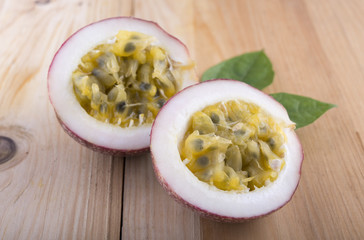 haft cut ripe passion fruit on wooden table