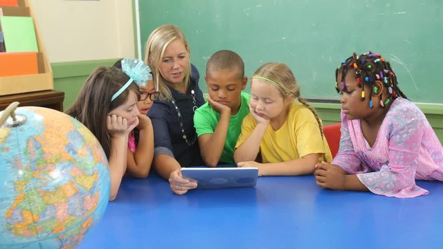 Teacher and students work on digital tablet