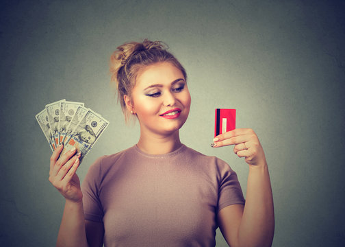 Woman with credit card and dollar cash happy with bank choice