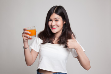 Young Asian woman thumbs up drink orange juice.