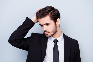 Close up photo of handsome confident man in suit touching his perfect black hair