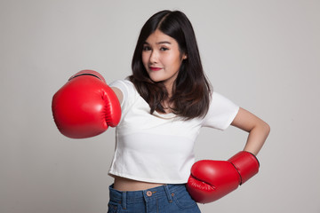 Young Asian woman with red boxing gloves.