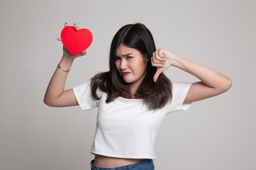 Asian woman thumbs down with red heart.