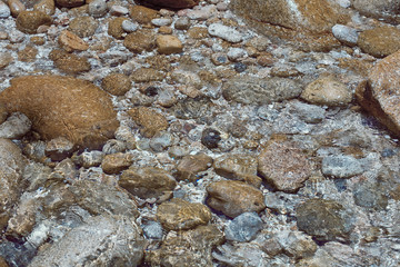 sea stones under water at the shore