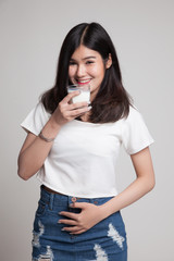 Healthy Asian woman drinking a glass of milk.