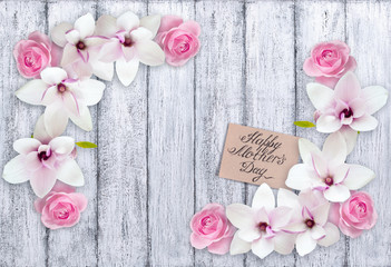 Magnolia with roses and paper greeting card for Mothers day