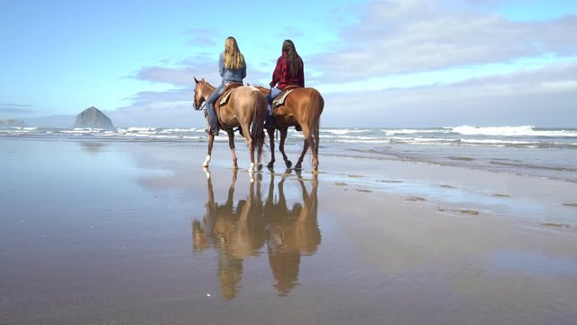 Women Riding Horses At Beach